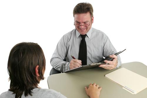 Guidance counselor talking to a teenager. Photo courtesy of Shutterstock.

