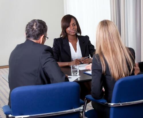Group of managers interviewing female job candidate. Photo courtesy of Shutterstock.

