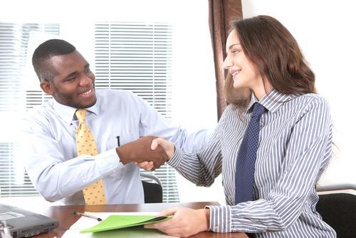 Congratulations, you&#8217;re hired! says manager to selected candidate. Photo courtesy of Shutterstock. 
