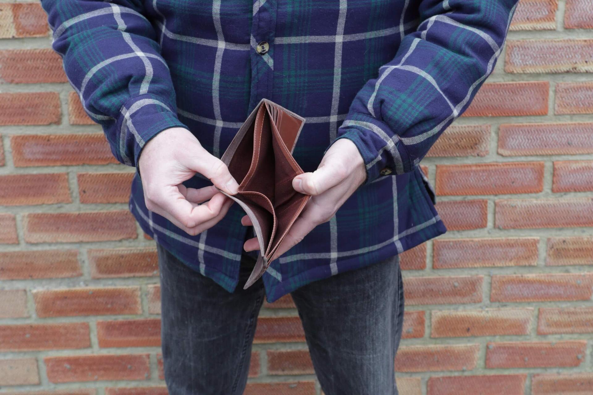 Man showing empty wallet
