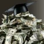Mortar Board Graduation Cap on Top of Pile of Money