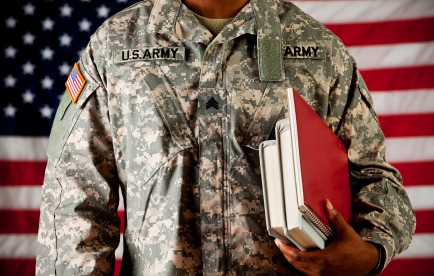 Army soldier carrying textbooks