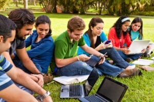 College students on laptops, tablets, and smartphones