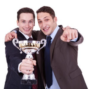 Two guys holding trophy