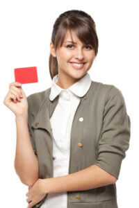 Woman smiling and holding a credit card