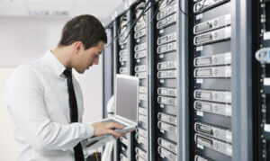IT engineer businessman using laptop in network server room