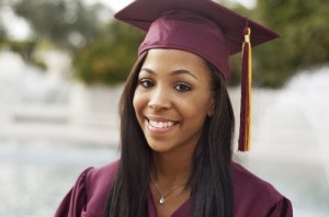 Young woman in graduation cap and gown. Photo courtesy of Shutterstock.