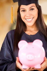 Female graduate holding piggyback with savings for education