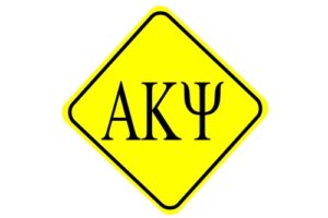 Greek letters representing a business fraternity on yellow and black sign