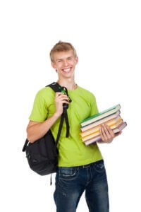 Young man carrying backpack and holding books