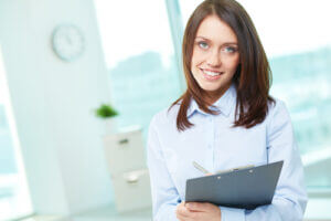 Female business intern holding a clipboard
