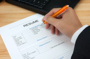 Someone filling out a resume