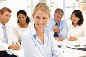Woman in front of her co-workers during a recruitment office meeting