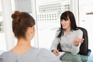 A business woman asking questions to candidate in an interview