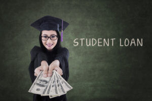 Young female graduate holding money from a student loan