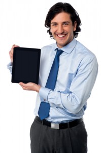 Smiling sales representative displaying a new tablet device