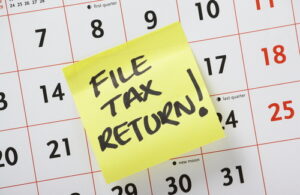 Yellow post it note about filing tax return