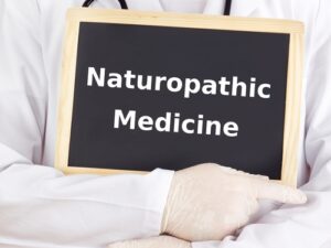 Doctor showing naturopathic medicine on chalkboard