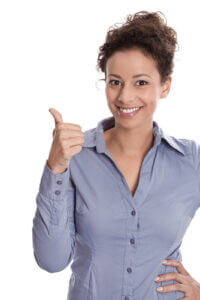 Happy student/young woman giving a thumbs up on getting first business job