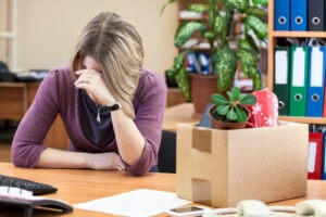 Woman crying at work after being dismissed