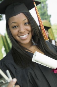Close up of smiling female college graduate holding her certificate