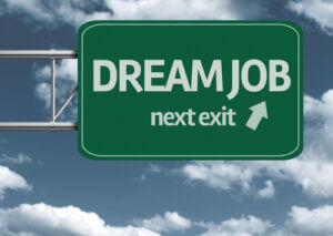 Dream job, next exit road sign with arrow and clouds in the background