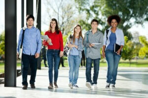 College students walking together in a row on campus