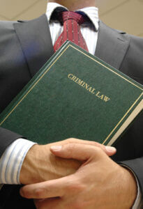 Lawyer holding a criminal law book