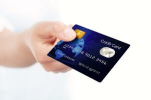 Closeup of hand holding a blue credit card