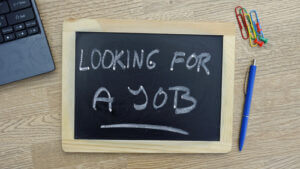 Looking for a job written on a chalkboard at the office