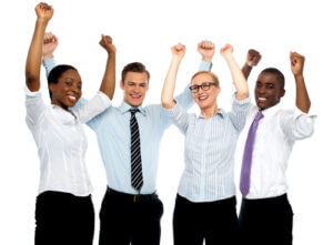 Business team celebrating success with arms raised