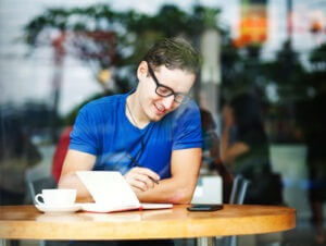 Young entrepreneur working in a cafe (soft focus) 