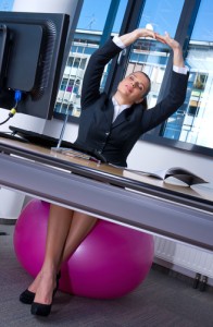 Business woman stretching in office 