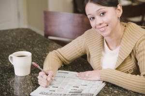 Woman searching newspaper classified ads
