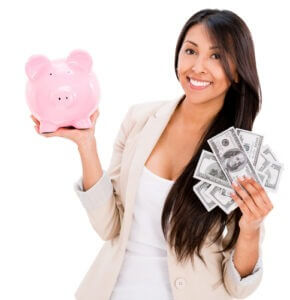 Woman saving money in a piggybank - isolated over white background 
