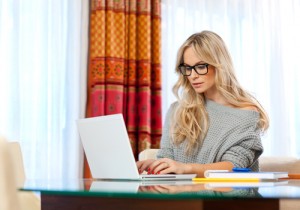 Woman writer in her home with laptop in creative process