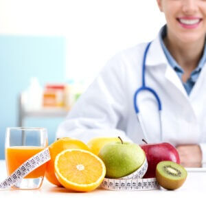 Healthcare professional promoting healthy eating, focus on fruit