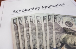 Scholarship application form with hundred dollar bills 