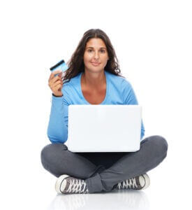 Smiling college student with credit card and laptop