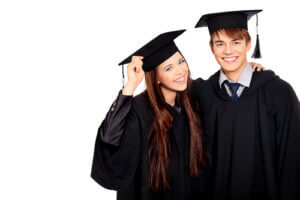 Portrait of two happy graduating students. Isolated over white background.