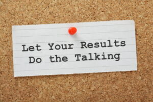 The phrase Let Your Results Do The Talking on a cork notice board. A concept for using your successes to move forward in your career or business.