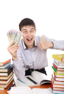happy student with a money at the school desk on the white background
