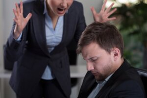 female boss yelling at employee at work