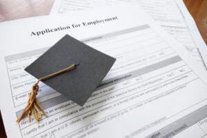 mini graduation cap on a job application form