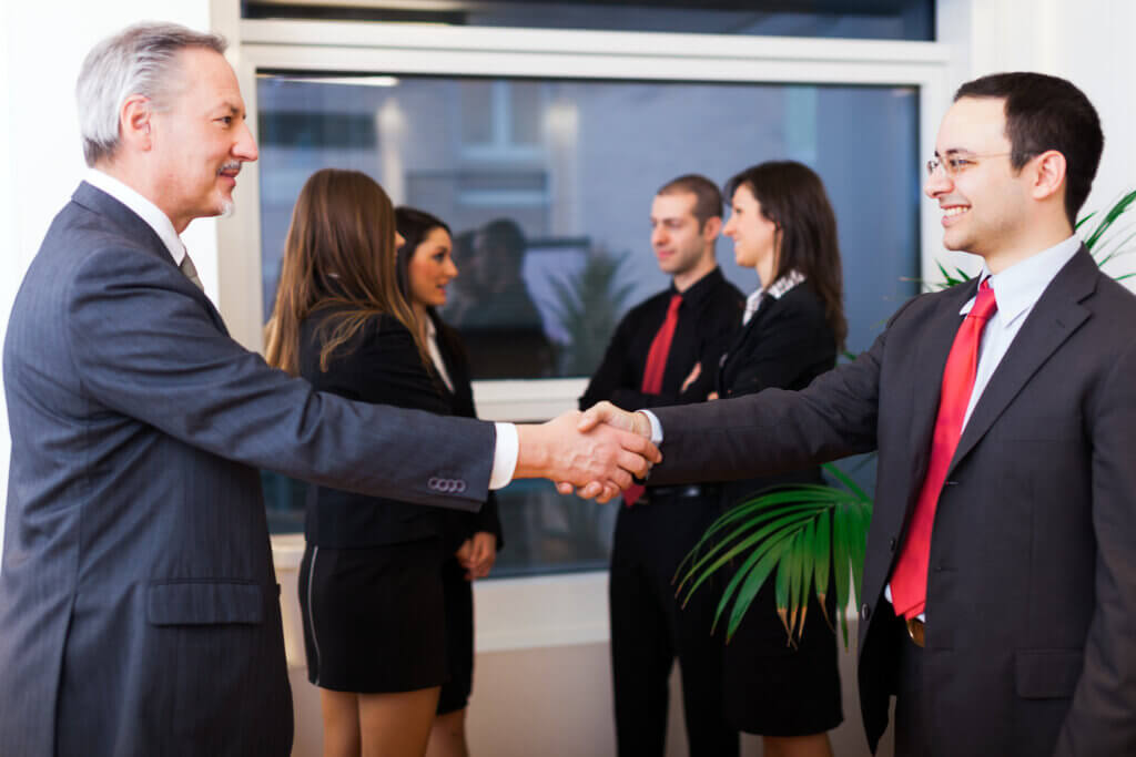 Businesspeople shaking hands at networking event