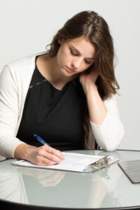 Woman filling out application during job search courtesy of Shutterstock.com
