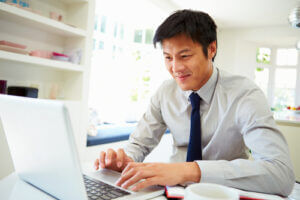 Businessman working from home on laptop courtesy of Shutterstock.com