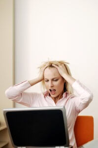 Frustrated businesswoman screaming photo by StockUnlimited.com